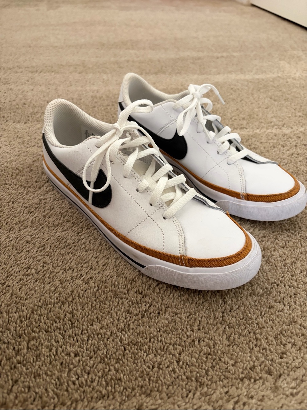 Nike White Sneakers with Black Swoosh and Brown Accent